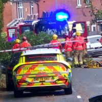 The driver of a car hit by a tree during yesterday's storm in Wigan may have suffered life-altering injuries