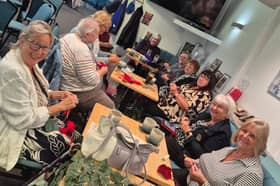 Knitters work on their poppies