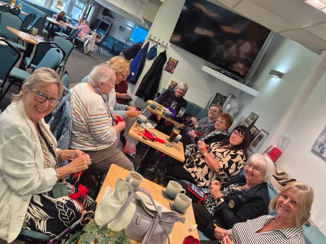Knitters work on their poppies