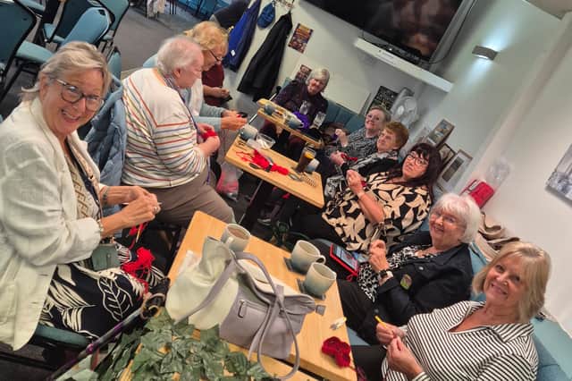 Knitters work on their poppies