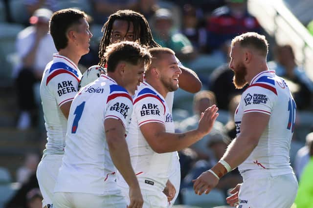 Mikey Lewis (centre) celebrates a try against France with his England teammates