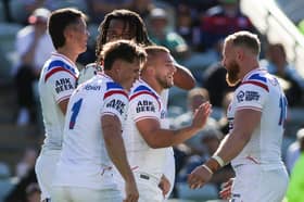 Mikey Lewis (centre) celebrates a try against France with his England teammates