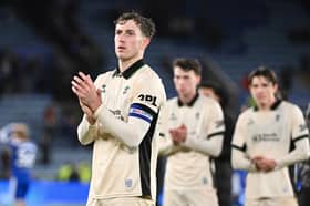 Jensen Weir applauds the Wigan Athletic fans following their defeat at Leicester City