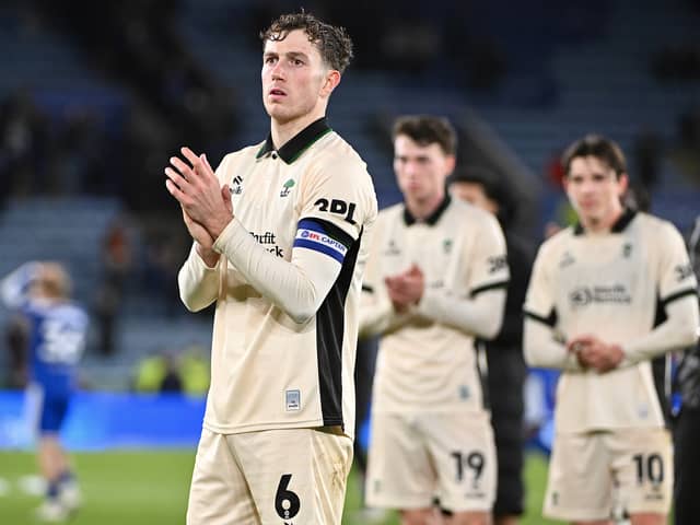 Jensen Weir applauds the Wigan Athletic fans following their defeat at Leicester City