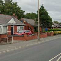 Firefighters rescue the occupant of a blazing Wigan borough bungalow