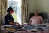 Heather Dainty, Deputy Ward Manager at Wigan & Leigh Hospice, chatting to a patient on the Inpatient Unit.