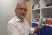 David Stanley holding dry eye products at Jackson Opticians in Wigan.