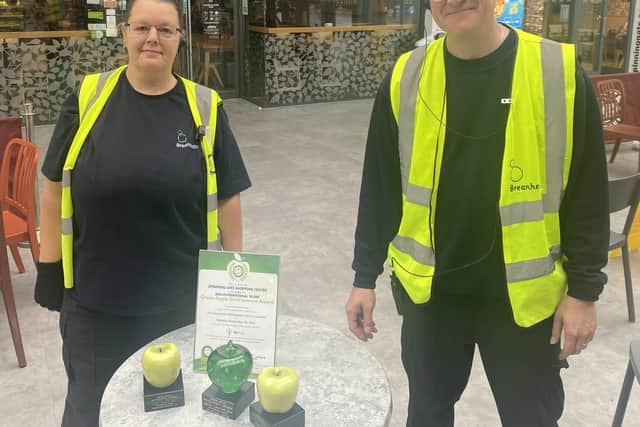 Cleaning team leader Sue Siddall  and team member David Williamson with previous trophies