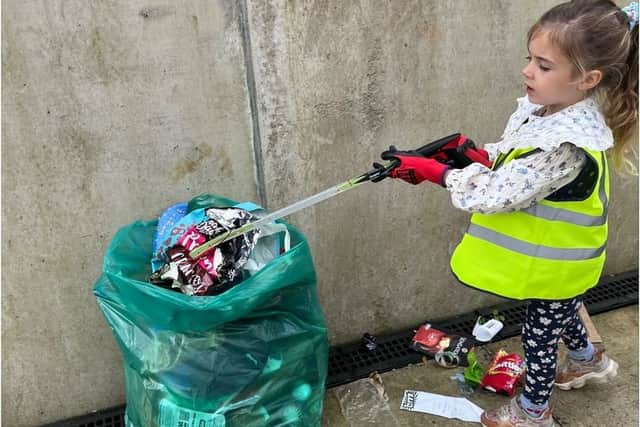 Reception pupil Carmela working hard to clean up her local area.