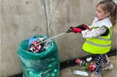 Reception pupil Carmela working hard to clean up her local area.