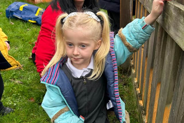 A volunteer helping a St Thomas the Martyr CE child plant daffodil bulbs