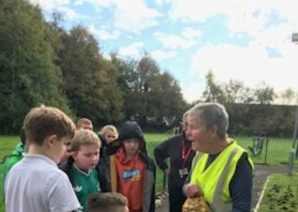 Gill Sinnott explaining how to plant the daffodil bulbs at St Thomas the Martyr CE Primary School