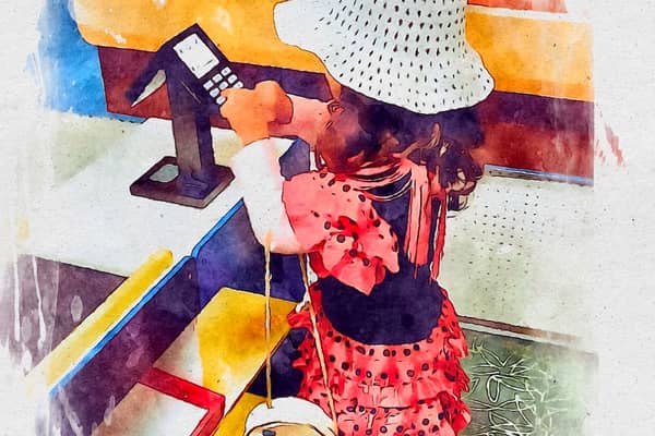 A dancing lady in a hat at a self-service till. 
