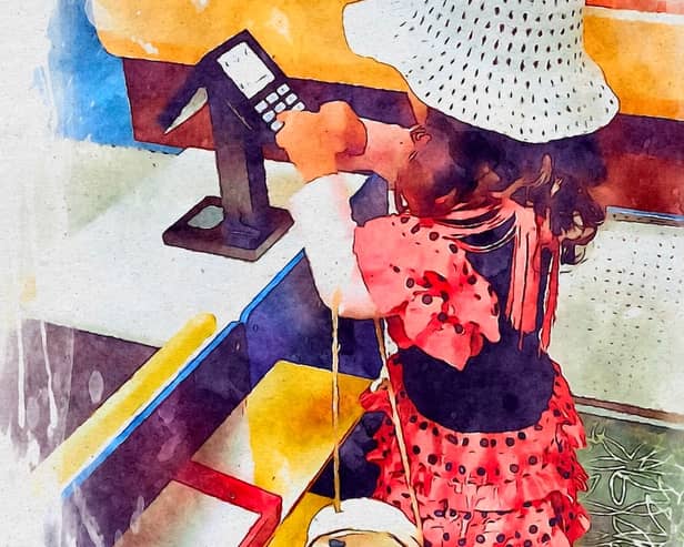 A dancing lady in a hat at a self-service till. 