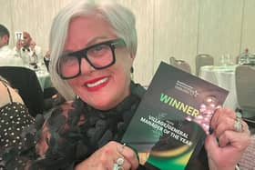 Belong Wigan general manager Gill Menguy with her award.