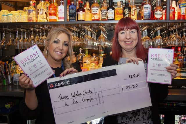 Alison Duncan, owner of Gin on the Lane, (right) presents Janet Ellison, Patient Navigator for the South Lancashire Breast Screening Service, with a donation to the In Pink campaign