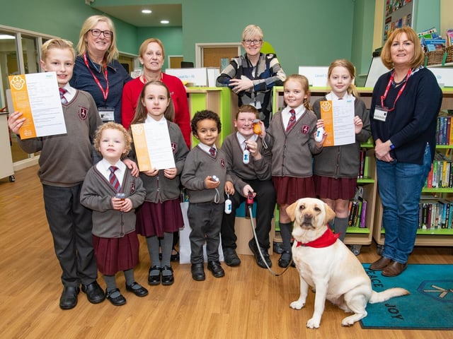 Thelma the therapy dog with St Thomas' CE Junior and Infant School pupils, headteacher Joanne Woods, Coun Susan Gambles, Coun Yvonne Klieve and Coun Gena Merrett