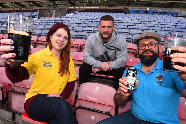 Members of Wigan CAMRA (Campaign for Real Ale) and organisers  of Wigan Beer Festival 2020, Jo Ashton, left, and Sandy Mottram, right, joined by Wigan Warriors player Shaun O'Loughlin, centre, at DW Stadium, at the launch of Wigan Beer Festival 2020
