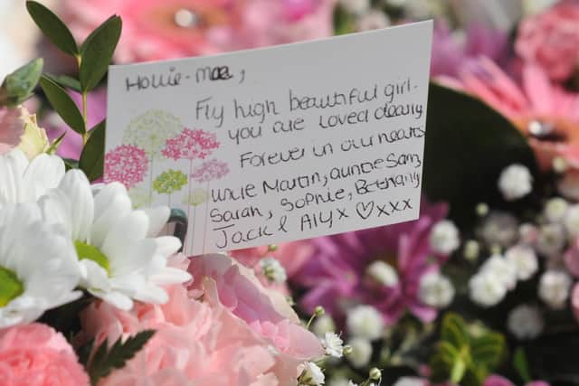 A card for Hollie on flowers at her funeral