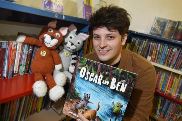 Author and illustrator Sean Perkins with his book, Oscar and Ben