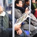 A man on an underground train wearing a protective mask