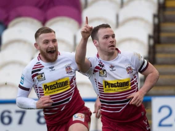 Liam Marshall celebrates a stunning solo try at Huddersfield
