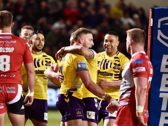 Jackson Hastings is congratulated on his try against his former club