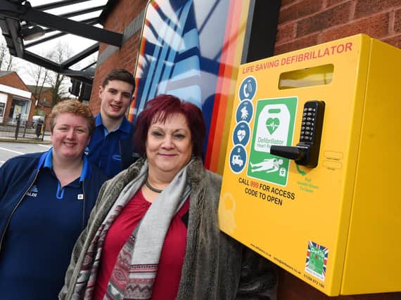 Coun Debbie Parkinson, right, next to the new defibrillator at Aldi with staff members Lisa Saile and Tom Winstanley