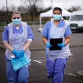 NHS nurses wait for the next patient at a drive through Coronavirus testing site