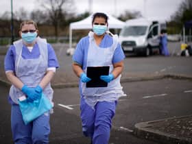 NHS nurses wait for the next patient at a drive through Coronavirus testing site