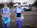 NHS nurses wait for the next patient at a drive through Coronavirus testing site