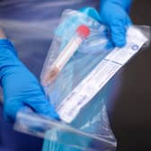 A NHS nurse holds a Coronavirus testing kit