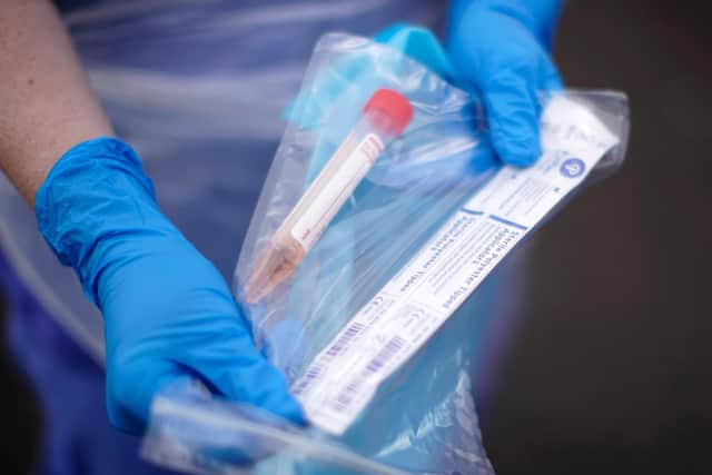 A NHS nurse holds a Coronavirus testing kit