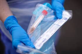 A NHS nurse holds a Coronavirus testing kit
