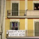 People applaud from a balcony during a flash mob called through social media and messaging platforms, aimed to thank workers in the fight against coronavirus on March 15, 2020 in Barcelona, Spain