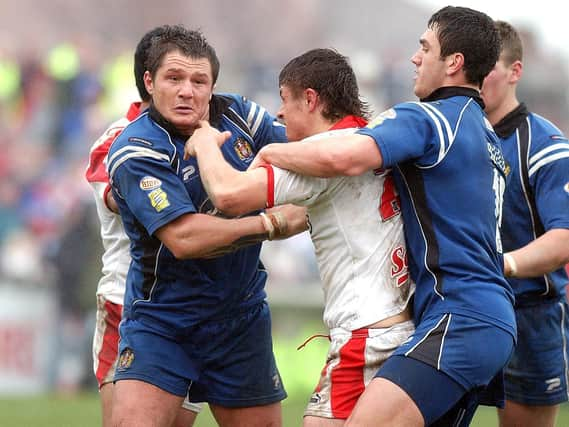 Stephen Wild tries to pin down Jon Wilkin's arms