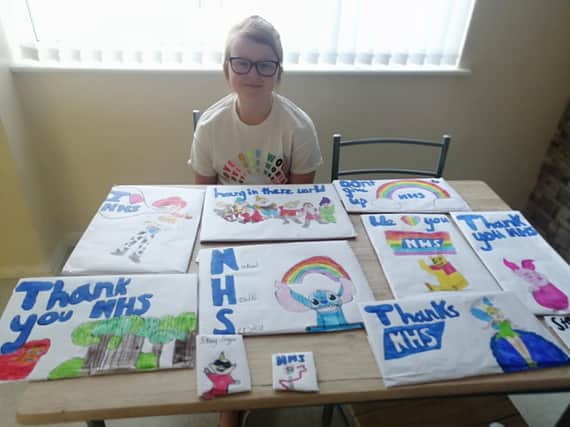 Ava Murray with her drawings