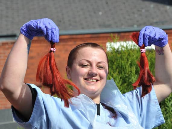 Steph Buckley, a support worker at Berkley House mental health care unit, Wigan, proudly shows off her new hairstyle after she was sponsored to have her head shaved to raise funds for residents to have a party after the Covid-19 lockdown has ended