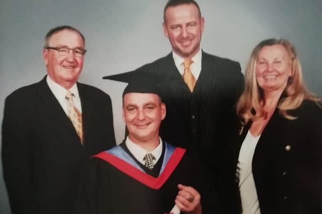 Aden graduating with his parents Tom and Jean and brother Craig