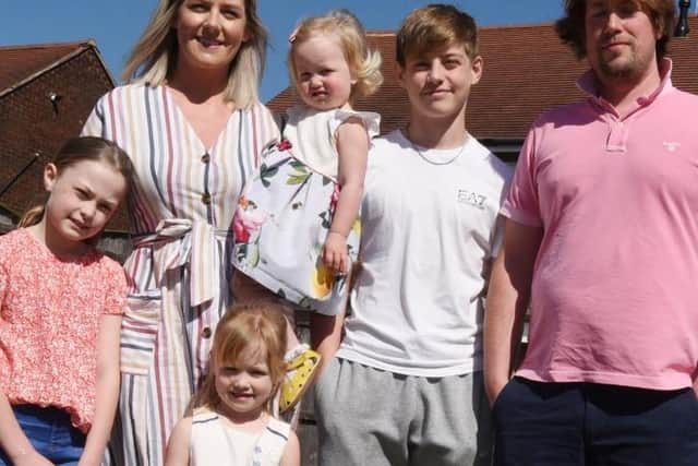 Jennie Cleary and Jonny Ashall from Orrell with kids,from left, Olivia, nine, Emily, three, Jessica, one, and Ethan,14, in their garden