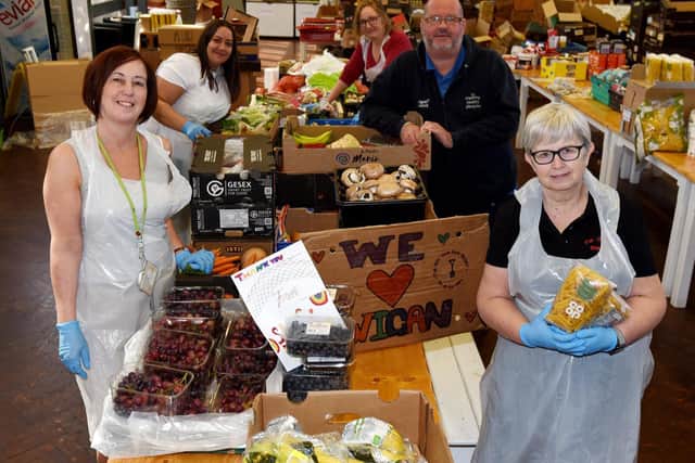 Wigan Council staff members, Lisa Caffery, Nicola Sentance and Julie Clarke, Martin Turner from Inspiring Healthy Lifestyles and Shirley Southworth, director at Fur Clempt Cafe, pictured at the food donation centre at Fur Clempt Wigan