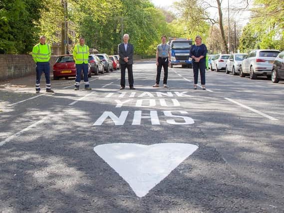 Coun David Molyneux, leader of the council and chief executive Alison McKenzie-Folan, stand by the new road markings outside Wigan Infirmary