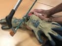 A firefighter cuts through handcuffs