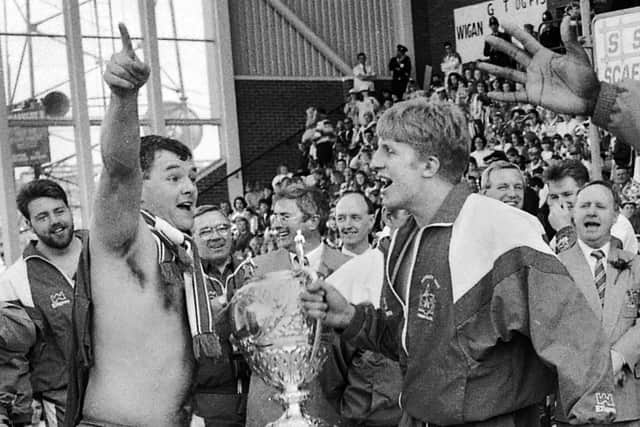 Jack Robinson (centre) at a homecoming, with Billy McGinty and Denis Betts leading the celebrations