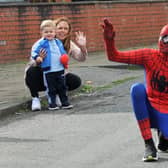 McKenzie Fisher dressed as superhero Spiderman, on Vine Street, Whelley, Wigan, to entertain children on their birthdays during the Covid-19 lockdown and raising funds for the NHS.