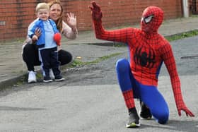 McKenzie Fisher dressed as superhero Spiderman, on Vine Street, Whelley, Wigan, to entertain children on their birthdays during the Covid-19 lockdown and raising funds for the NHS.