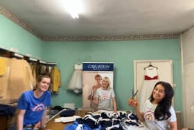 Volunteers hard at work making scrubs
