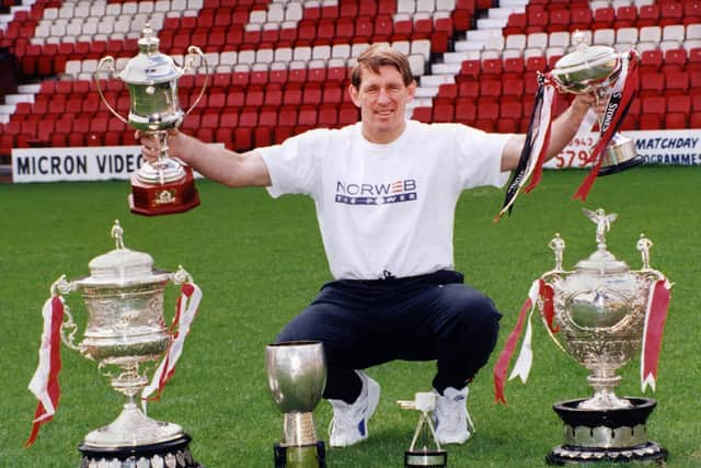 Coach Graeme West with the silverware