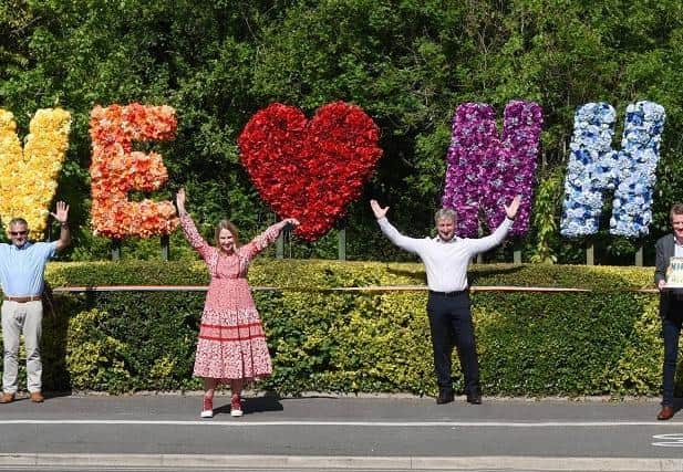 Our pictures show some of the florists and sponsors who created the large floral sculpture at The Cherries Community Garden, Wigan Lane; Sarah Crookston from The Rose Boutique; Coun Lawrence Hunt with some of the pompoms made by members of the community and Kerry Docherty from Wild Flowers