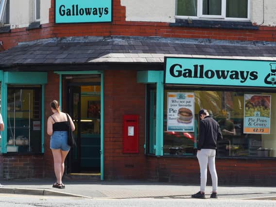 Customers queue today outside Galloways in Gidlow Lane.